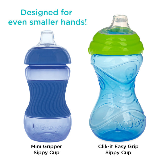 Two blue Nuby sippy cups side by side—one with a dark blue lid, labeled Mini Gripper Soft Spout Sippy Cup with Sleeve, and one with a green lid. Both feature soft spouts designed for even smaller hands!.