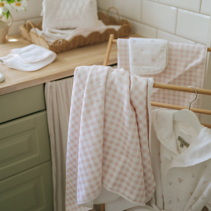 Children's hooded towel in Pink Gingham in a bathroom setting.