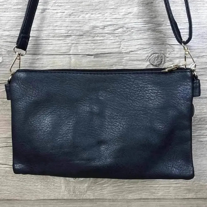 Navy PU leather sling bag with adjustable strap and multiple zip compartments