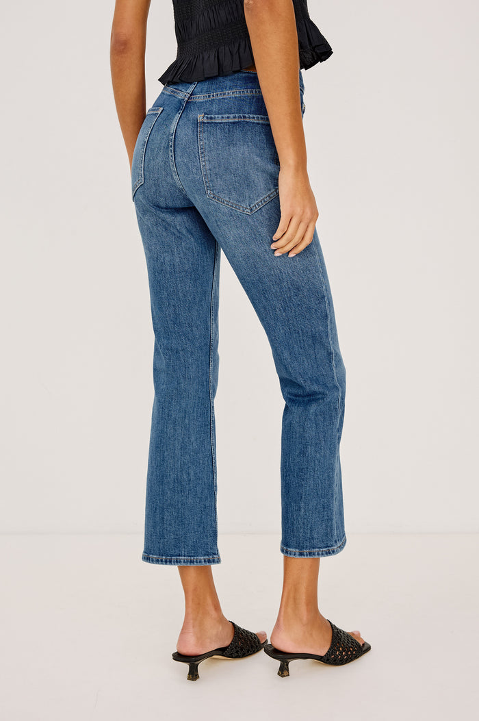 Sunset Crop Slim Flare Jean in Light Stretch Denim With High-Waisted Fit and Zip Fly in Tidal Wavey Colorway - Lower Body Back View Featured on Model