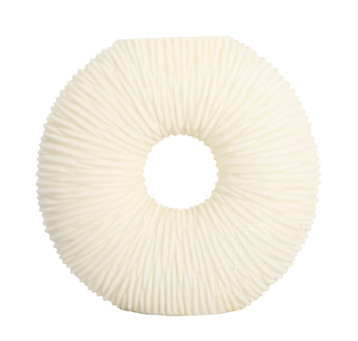 Round ivory vase with a hole in the middle and textured surface.