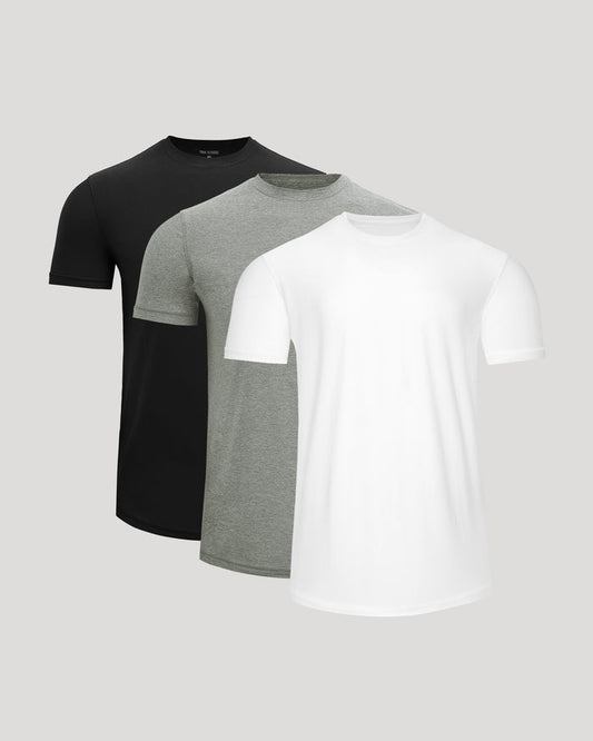 Three short-sleeve crew-neck t-shirts in black, heather gray, and white, arranged in a layered overlapping display against a light gray background.