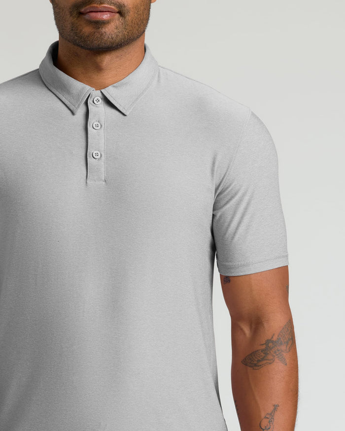 Close-up of a man wearing a Light Heather Gray Active Polo 2.0 with short sleeves and a three-button placket, showcasing a smooth, lightweight fabric for men's basics.