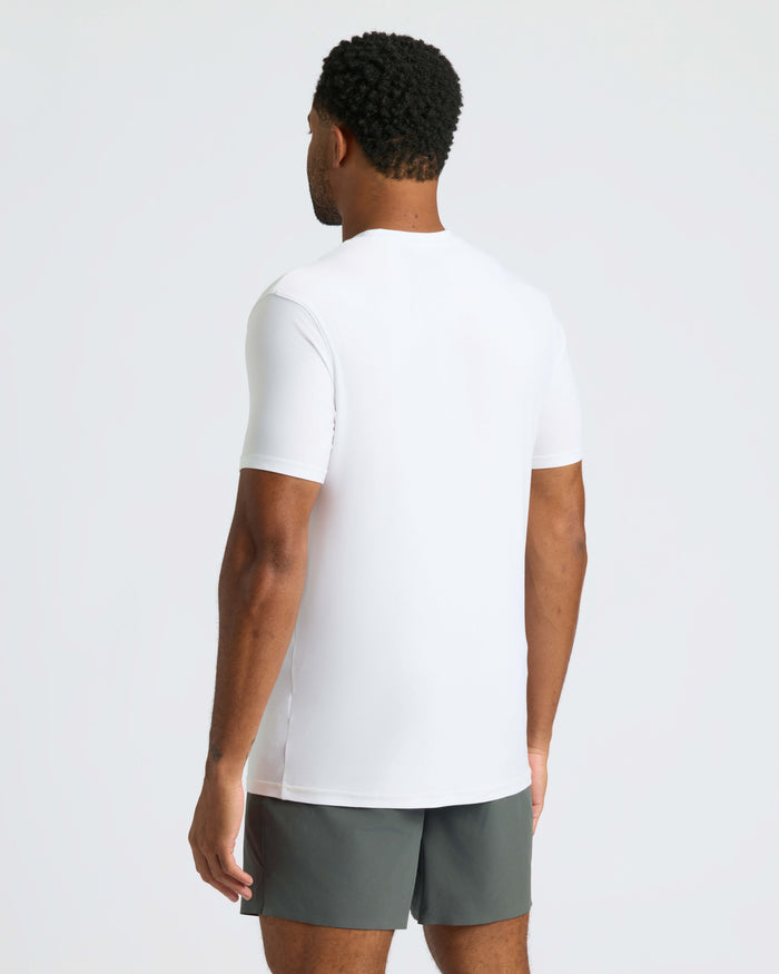 Man in White Active Crew Neck Tee and charcoal shorts, back view.