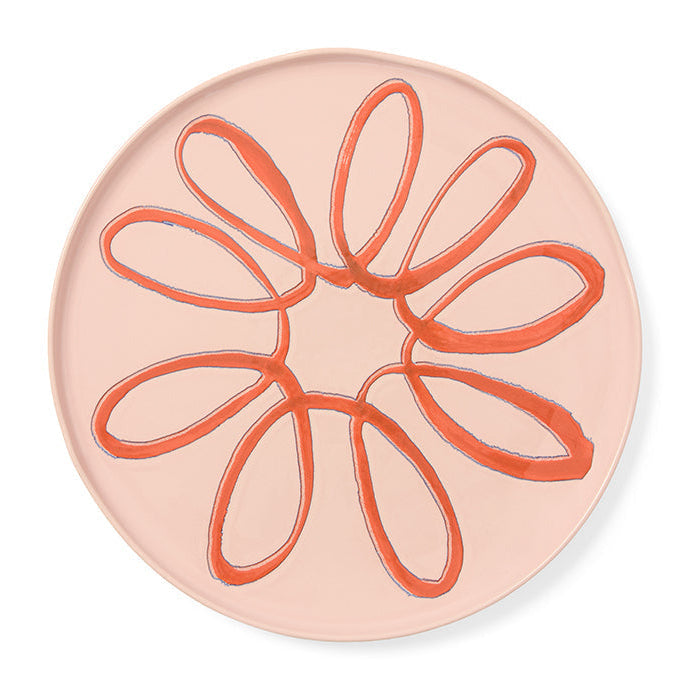 Round pink dish with a design on a white background