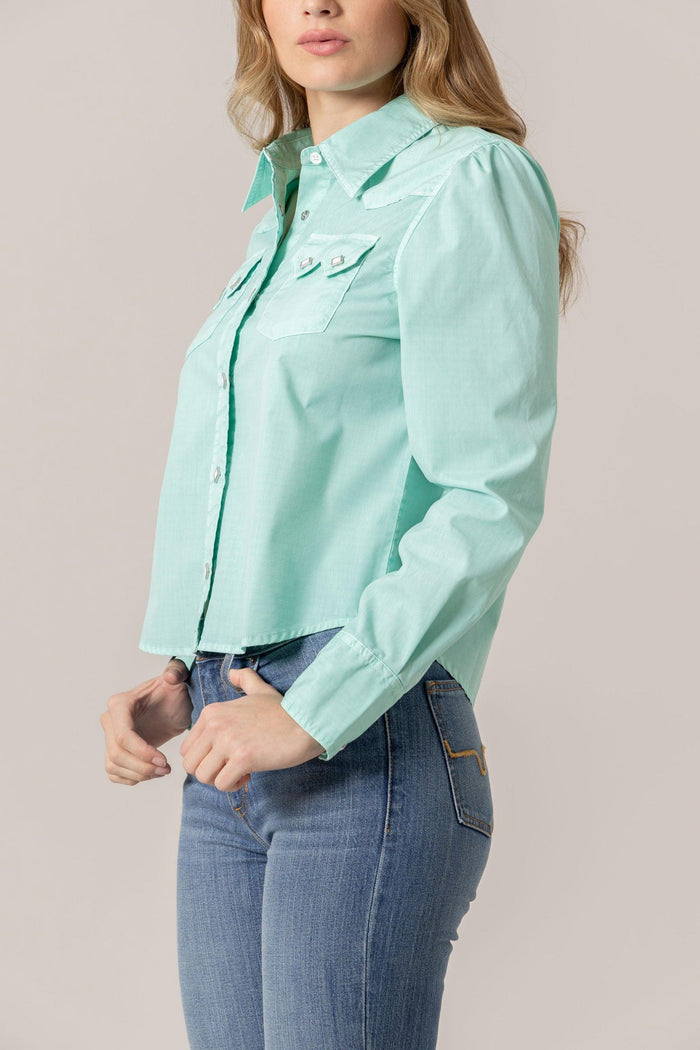 Annie in turquoise button-up crop top