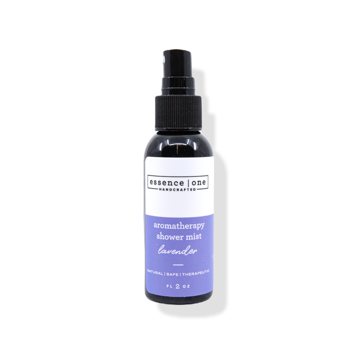 A black spray bottle of Aromatherapy Shower Mist | Essence One featuring a lavender scent, labeled as natural, safe, and therapeutic for body care and wellness.