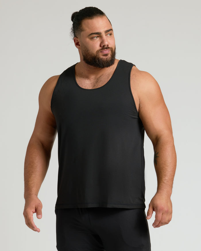 Black Sleeveless Active Mesh Tank 3-Pack on muscular man, neutral gray backdrop.