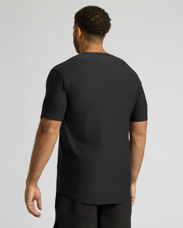 Man wearing a black t-shirt on a light gray background