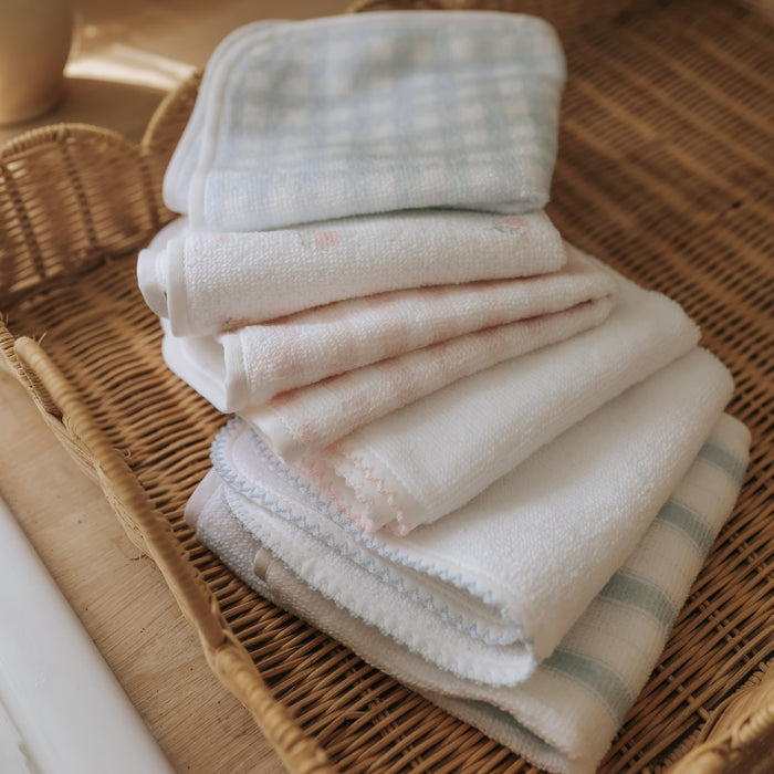 Stack of folded towels on a woven basket