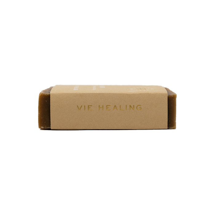 Side view of a brown bar of Coffee Sabun Soap | Vie Healing wrapped in a simple kraft paper label, emphasizing natural skincare and body care.