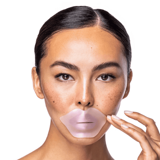Close-up of a woman applying the Diamond Radiance Collagen Lip Mask | KNESKO, a translucent pink skincare lip treatment designed to hydrate and rejuvenate lips.