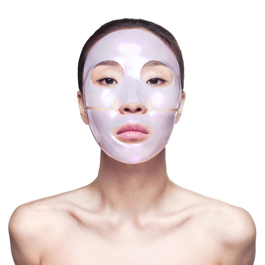 Woman wearing a pearlescent skincare sheet mask with cutouts for eyes, nose, and mouth, showcasing the Diamond Radiance Face Mask - Single | Knesko for facial wellness and skincare.