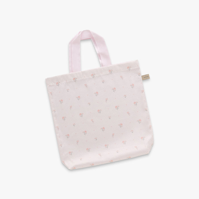 Pink tote bag with subtle floral pattern on a light gray background