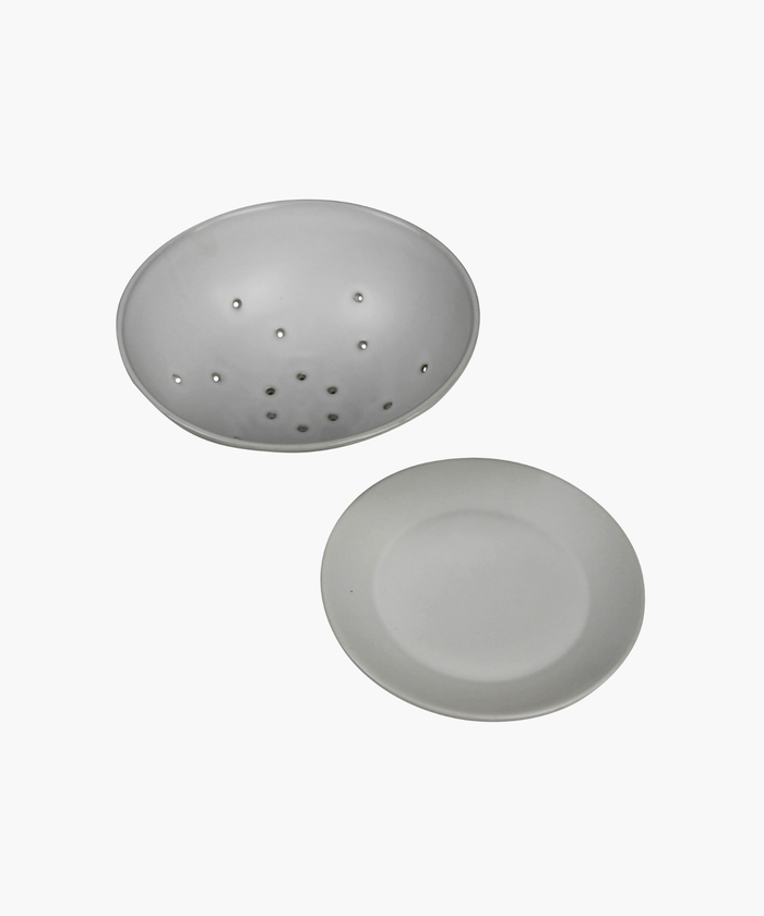 White ceramic colander with matching base plate. The minimalist design features a smooth matte finish, subtle curves, and small drainage holes.| SW Home
