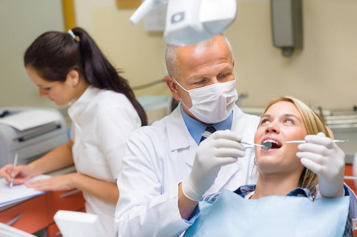 Dentist wearing EARasers Dentists & Hygienists Hi-Fi Earplugs