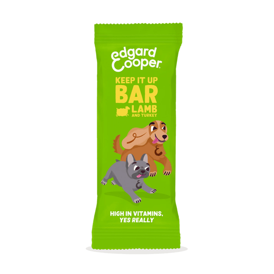 White background with an green packet of Edgard & Cooper Keep it Up Lamb & Turkey Bar pictured. On the packet is an illustrated French Bulldog and Cocker Spaniel. Text on the pack reads, 'Edgard & Cooper, Keep it Up Bar,  Lamb & Turkey. High in Vitamins, yes really.'