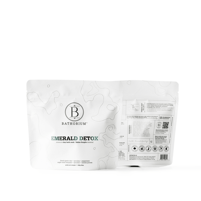 Front and back view of a white resealable pouch of Emerald Detox Clay Mineral Soak | Bathorium, featuring minimalist topographic design and product information for skincare and body care wellness.
