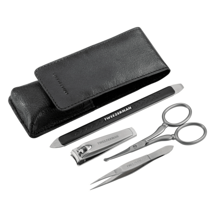 Essential Grooming Kit | Tweezerman featuring a black carrying case, nail clippers, tweezers, scissors, and a double-ended metal nail file for precise grooming and skincare.