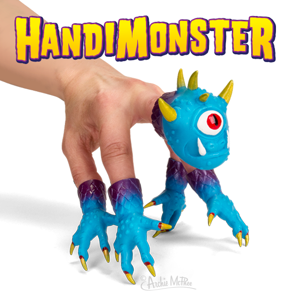 A blue Handimonster puppet, featuring one eye and horns, fits on fingers under the "HandiMonster" text, providing a playful twist as a germaphobe accessory.