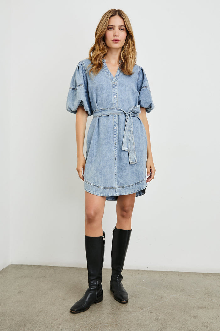 Kingsley Denim Mini Dress with Elbow-Length Puff Sleeves, a V Neck, Snaps Down the Front and a Fabric Tie Belt in Faded Indigo Colorway - Front Full Body View Featured on Model