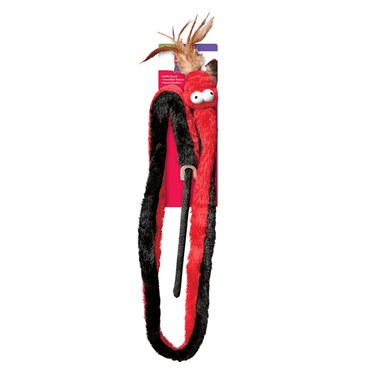 Long red and black faux fur snake cat toy attached to a rod, feathers attached to mouth and cartoon style fabric eyes. Snake is attached to red cardboard backing. Pictured on a white background.