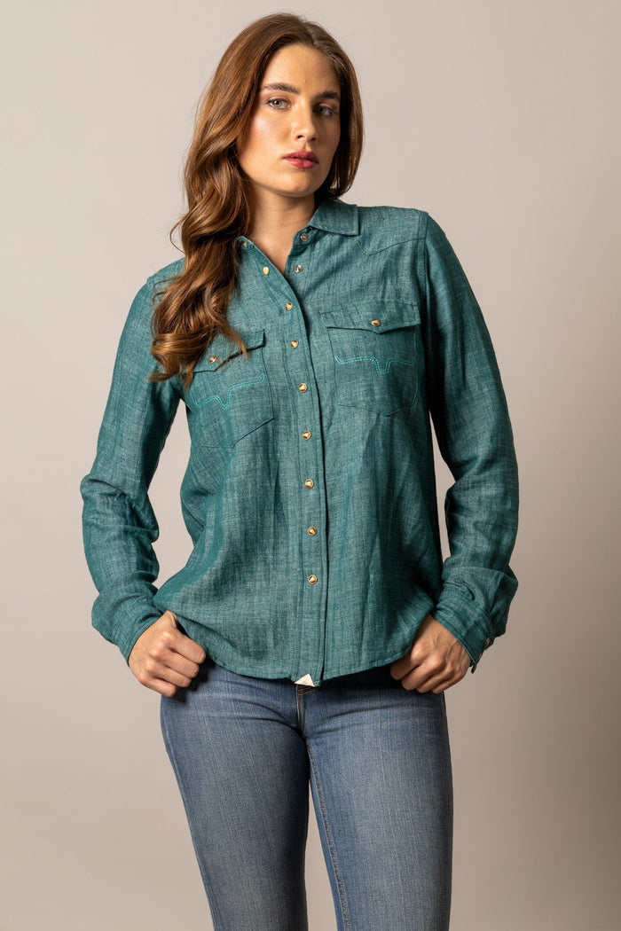 Woman in teal denim shirt and jeans