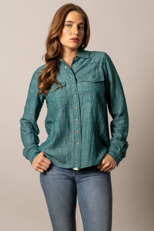 Woman in teal denim shirt and jeans