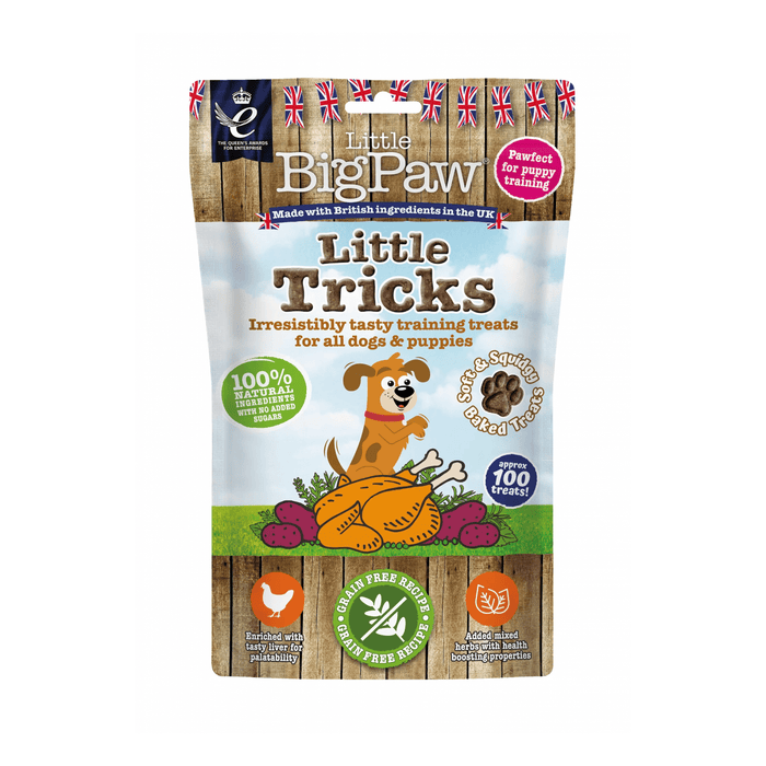 White background with a packet of Little BigPaw 'Little Tricks' dog treats. Pictured on the packet is an illustration of a brown dog with a cooked chicken and vegetables in the foreground. Text on the bag says 'Irresistibly tasty training treats for all dogs & puppies, 100% natural ingredients, soft & squidgy baked treats. Approx. 100 treats!'