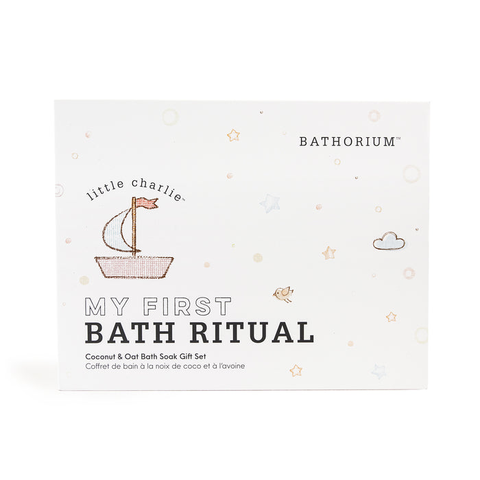 Packaging of little charlie™ My First Bath Ritual Gift Box Set | Bathorium featuring a simple boat illustration and soft pastel star and cloud accents on a white background.