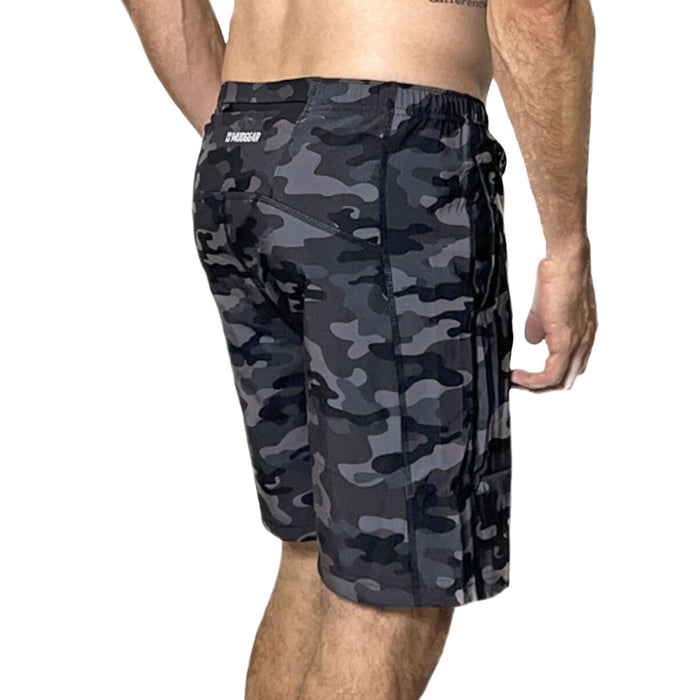 Man wearing black and gray camo freestyle running shorts with back zipper pocket