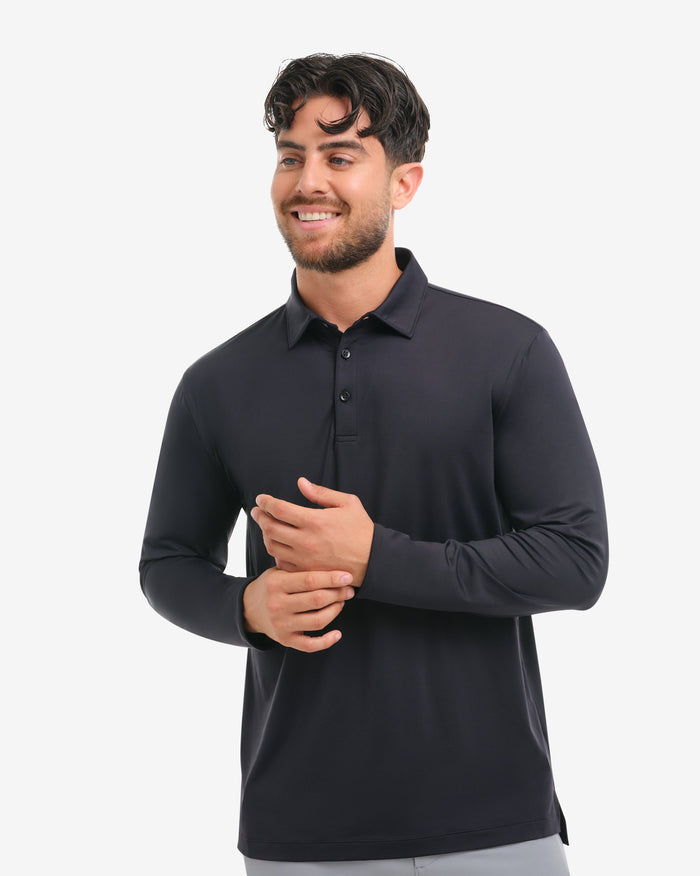 Man wearing a black long-sleeve shirt and gray pants on a white background