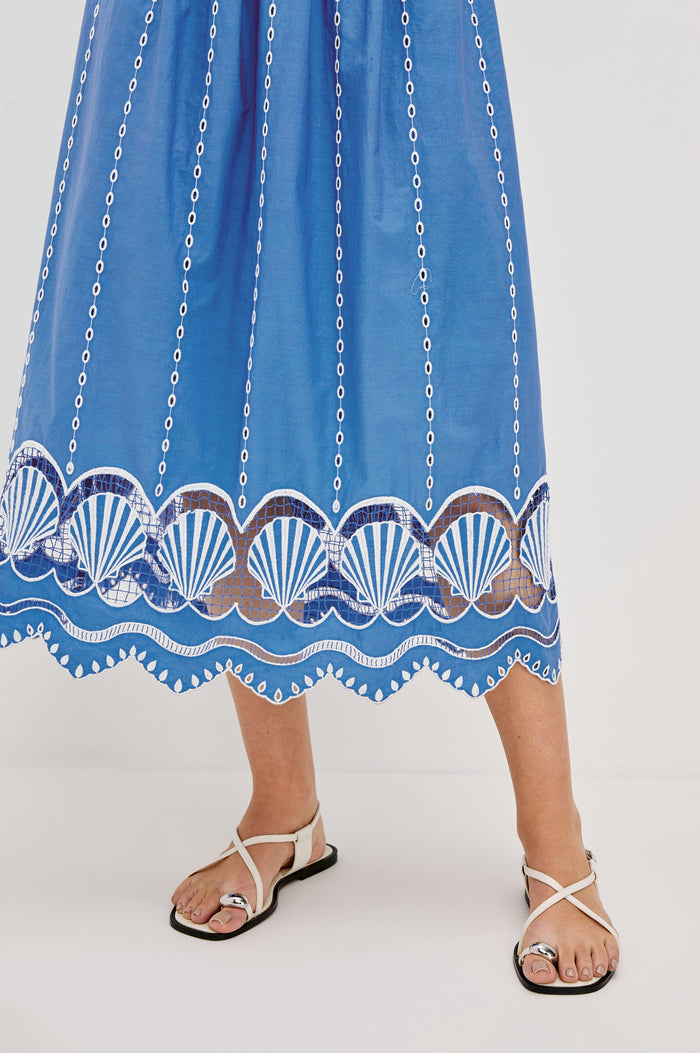 Murano Midi Tank Dress with Spaghetti Straps, Gathered Elastic Waistband, Sea Shell Embroidery and Scalloped Hem in French Blue Colorway. Front Detail View Shown on Model.
