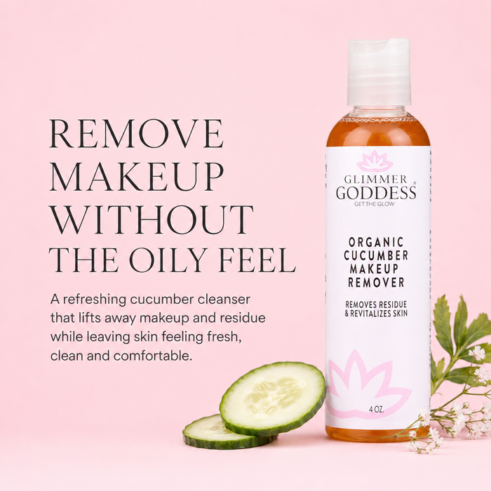 Glimmer Goddess Organic Cucumber Makeup Remover in a 4 oz clear bottle with a white cap and white label, set against a soft pink background with cucumber slices and white blossoms. Text on the left reads 'REMOVE MAKEUP WITHOUT THE OILY FEEL'.