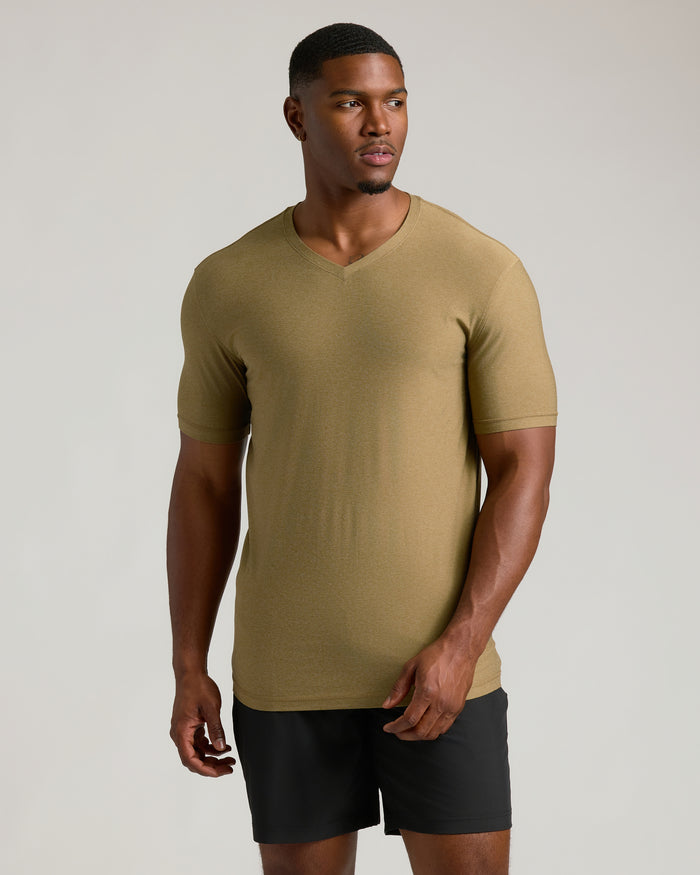 Man in Overland Tall Active V-Neck and athletic shorts.