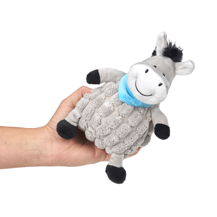 Hand holding grey donkey dog toy with back mane, tail and hoofs wearing a blue neckerchief on a white background.