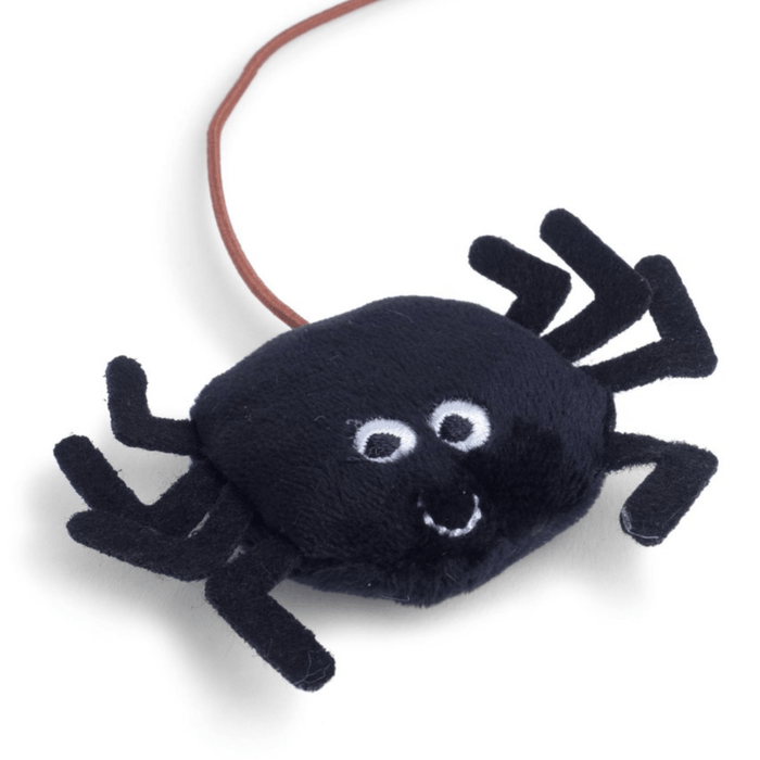 Close up of black spider cat toy on a fishing-style rod with stitched eye and smile details. On a white background.