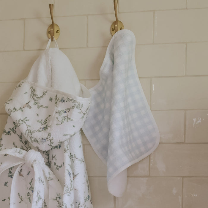 washcloth of blue gingham hanging on wall