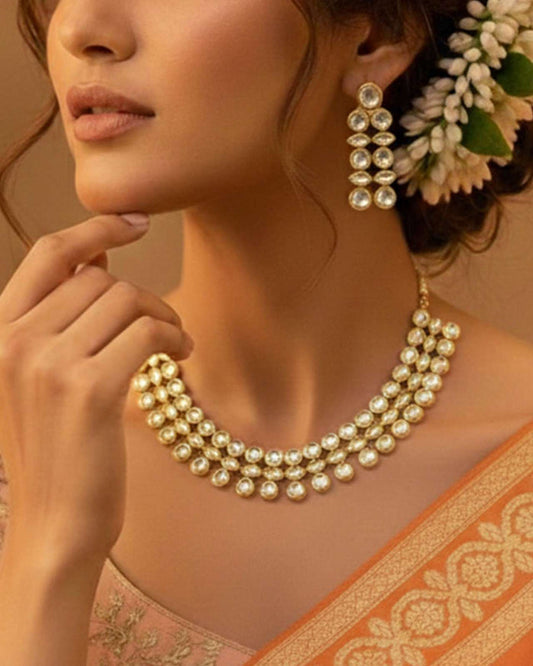 Gold and ivory kundan-style collar necklace with layered pearl-like discs and chain