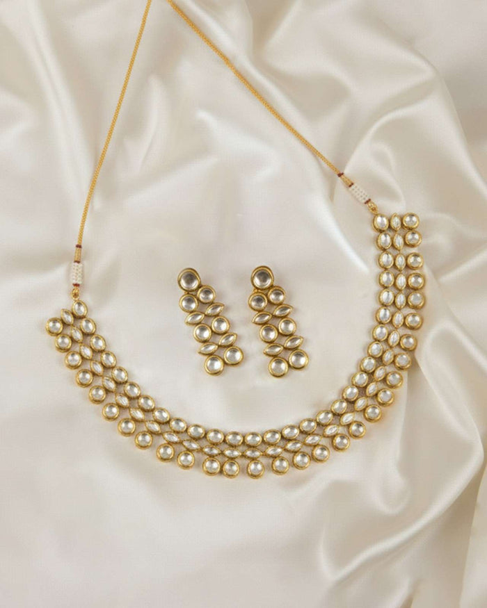 Gold-tone necklace set with layered pearl-like bead collar and matching earrings