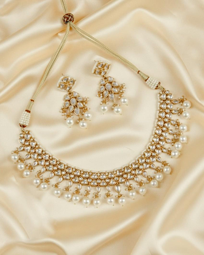 Gold kundan necklace set with pearl fringe and matching kundan stud earrings