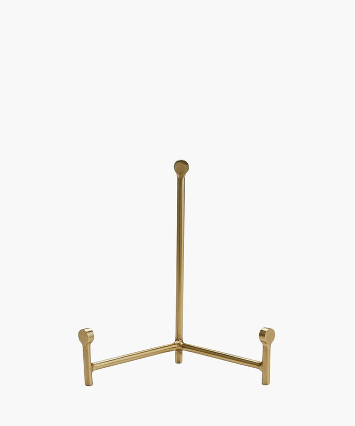 A sleek, gold easel with three legs, standing upright on a white background. The design is minimalistic, conveying elegance and simplicity. | SW Home