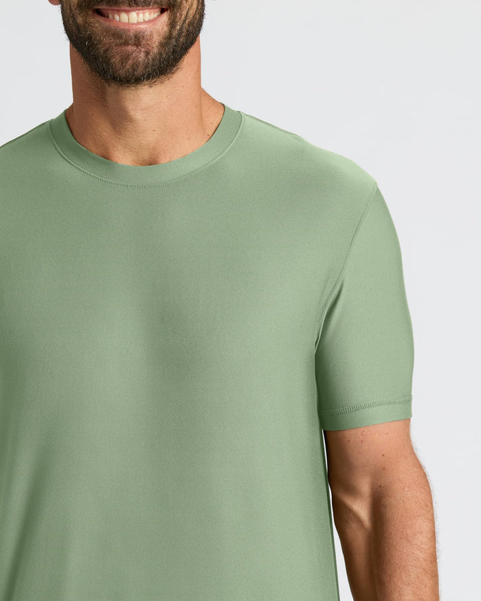 Person wearing a green t-shirt against a plain background
