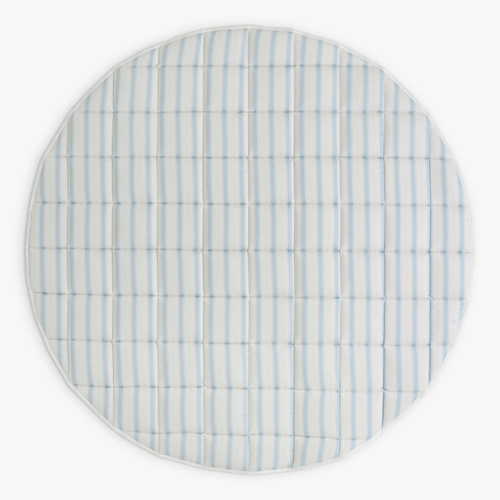Round playmat with blue and white striped pattern on a white background