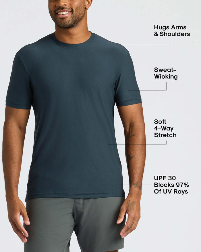 Man wearing a dark gray t-shirt with text highlighting features on a white background