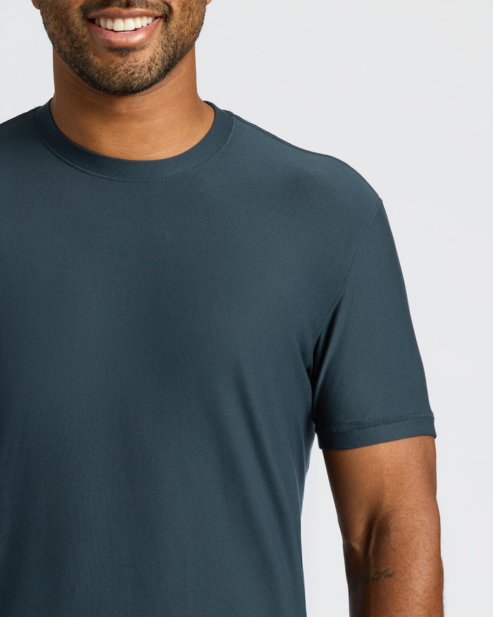 Man wearing a dark blue t-shirt against a plain background