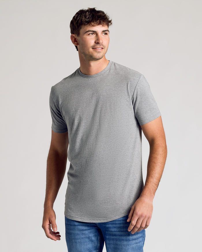 Tall man wearing Short Sleeve Tall Curved Hem Crew, gray T-shirt, blue jeans.