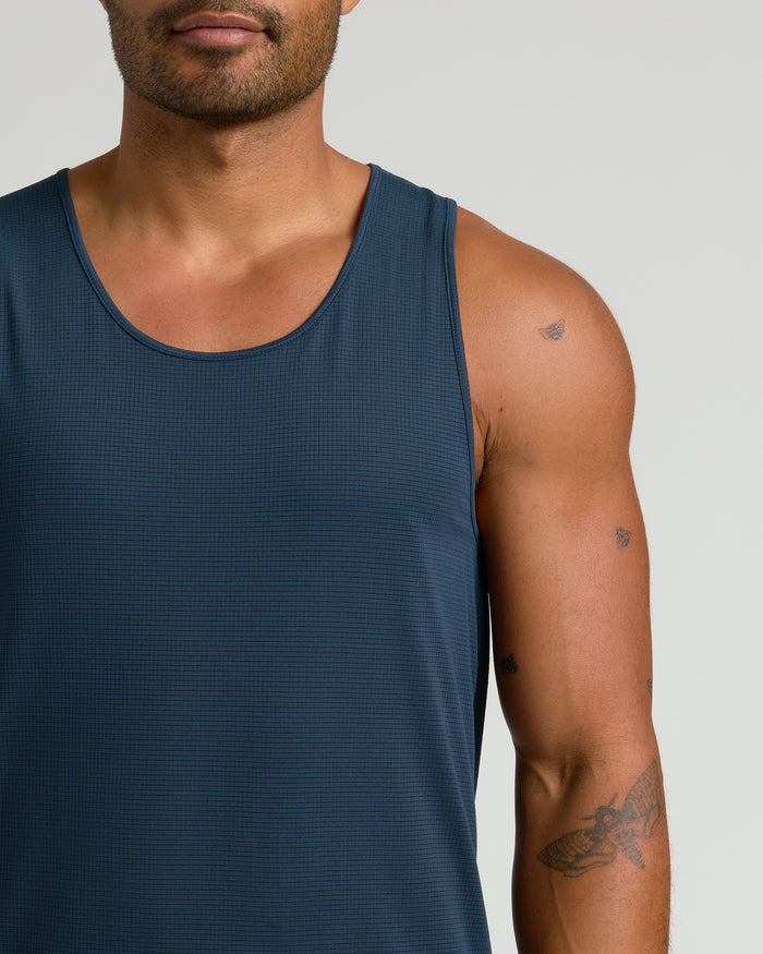 Man in dark teal Sleeveless Active Mesh Tank 3-Pack, showcasing tattoos.