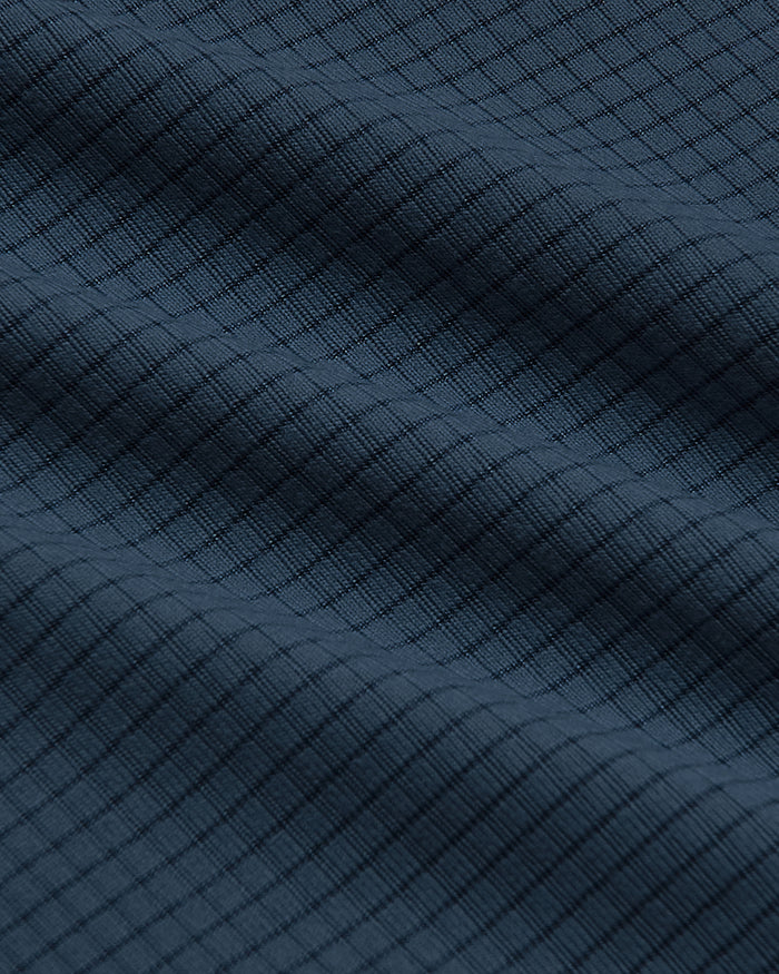 Close-up of Sleeveless Active Mesh Tank's textured dark blue fabric.