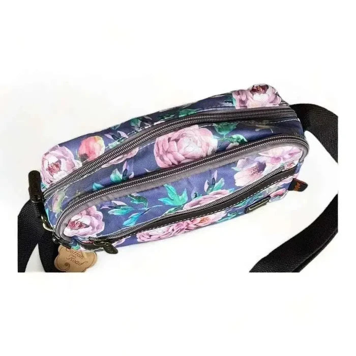 Canvas sling bag with purple flowers and multiple zip compartments